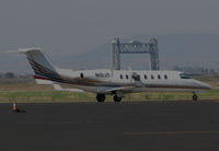 N10JY @ KAPC - Millennium Aviation (Rochester, NY) 1999 Learjet 45 taxiing for takeoff @ Napa County Regional Airport, CA - iconic Napa River RR Bridge visible through the heat waves - by Steve Nation