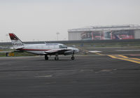 N45004 @ KOAK - Ameriflight 1980 Piper PA-31-350 ready to roll from Oakland Int'l North Ramp for a busy day collecting freight and mail across Northern California - note Cadillac commercial on old UA hangar across field - by Steve Nation