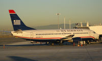 N332AW @ KOAK - US Airways 1987 Boeing 737-3B7 loading passengers @ Oakland International airport, CA (photographed from Southwest Airlines early morning KOAK-KBUR flight) - by Steve Nation