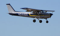 N24460 @ KRHV - Flying Twenty 1977 Cessna 152 over the threshold @ Reid-Hillview Airport, San Jose, CA (cancelled from U.S. Register March 10, 2011) - by Steve Nation