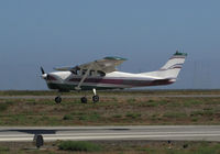 N9402T @ KSQL - 1960 Cessna 210 arriving from North Dakora over the threshold @ San Carlos Airport, CA - by Steve Nation
