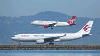 N634VA @ SFO - Airbus A320 over an Airbus A330 at San Francisco. - by Bill Larkins