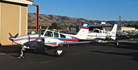 N427KM @ KRHV - Locally-based 1974 Beechcraft Baron 55 sitting in front of the Lafferty hangar at Reid Hillview Airport, San Jose, CA. It is currently for sale: www.laffertyair.com - by Chris Leipelt