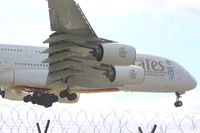 A6-EDU @ EGCC - about to touchdown on runway 23r, taken from The Airport Inn garden viewing area,