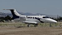 N122CR @ E16 - Locally-based 2013 Embraer Phenom 100 taxing to its hangar at South County Airport, San Martin, CA. Owned by Christopher Ranch LLC, a garlic farm out of nearby Gilroy. - by Chris Leipelt