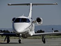 N122CR @ E16 - Locally-based 2013 Embraer Phenom 100 taxing to its hangar at South County Airport, San Martin, CA. Owned by Christopher Ranch LLC, a garlic farm out of nearby Gilroy. - by Chris Leipelt