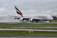 A6-EDI @ EGCC - just landed on 23R very wet runway - by andy santini