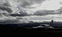 N6867L @ KRHV - Locally-based Cessna 421C parked on its tie down with a nasty storm rolling in at Reid Hillview Airport, San Jose, CA - by Chris Leipelt