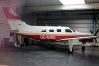 OO-NMU @ EBAW - Piper PA-46-350P Malibu Mirage JetPROP DLX [4636132] Antwerp-Deurne~OO 11/08/2010. Taken through glass of hangar window. - by Ray Barber