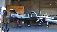 N48DJ @ KVCB - Oregon-based 1965 Beechcraft T-42A Cochise parked inside the maintenance hangar at Nut Tree Airport, Vacaville, CA. - by Chris Leipelt