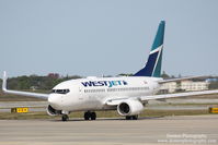 C-FWSF @ KSRQ - WestJet Flight 1187 (C-FWSF)  prepares for flight at Sarasota-Bradenton International Airport - by Donten Photography