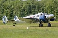 N223CM @ LFFQ - Beech D18S, Taxiing to parking area, La Ferté-Alais airfield (LFFQ) Airshow 2015 - by Yves-Q