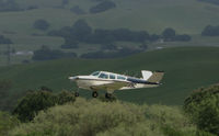 N3099C @ O69 - 1958 Beech K35 Bonanza climbing out from Petaluma Municipal Airport, CA between rain showers - by Steve Nation
