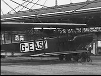G-EAZY - Shows crew pushing G-EASY from London hangar, wings still folded, for English Channel Crossing in 1923. Still from public domain 1923 film,  - by Unknown