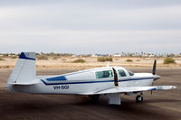 VH-SGI @ YCAR - Mooney M20J being readied for flight at Carnarvon airport, Western Australia