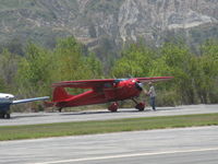 N195H @ SZP - 1948 Cessna 195, Jacobs R-755-A2 300 Hp radial, pulling the prop through rotations prior to engine start. Always do this before starting a radial engine. - by Doug Robertson