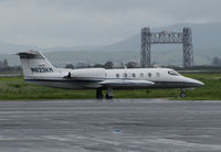 N623KM @ KAPC - Quarry Lane LLC (Chatsworth, CA) 1980 Gates Learjet 35A leaving rainy Napa County Airport, CA for flight to KSBA (iconic Napa River Railroad Bridge in background) - by Steve Nation