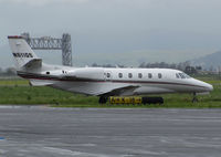 N611QS @ KAPC - NetJets 2005 Cessna 560XL Citation Excel leaving rainy Napa County Airport, CA for quick repositioning flight to KSCK (historic Napa River Railroad Bridge in background) - by Steve Nation