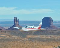 N5282T - N5282T over Monument Valley - by Bonnie Ackerman