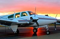 N1835B @ KRHV - California-based 1977 Beechcraft Baron 55 parked on the transient ramp during sunset at Reid Hillview Airport, San Jose, CA. - by Chris Leipelt