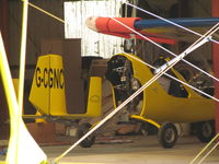 G-CGNC @ EGHA - snug in hangar - by magnaman