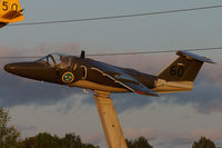 60080 - On the motorway E4 around Linköping you find several SAAB aircraft on display, most of them ex Swedish Air Force. 
This picture was taken was taken a few minutes before sunset.
