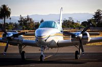 N333W @ KRHV - Grecmar Air Inc (Wilmington, DE) 1979 Beechcraft Baron E-55 parked on the transient ramp during sunset at Reid Hillview Airport, San Jose, CA. - by Chris Leipelt