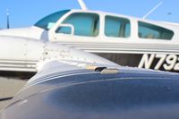 N7928R @ E16 - Locally-based 1969 Beechcraft Baron 55 parked on the ramp with morning mist at South County Airport, San Martin, CA. - by Chris Leipelt