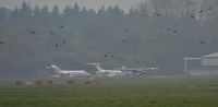 N182QA @ EGHH - Distant shot of N182QA departing through thick mist...and a flock of rooks - by John Coates