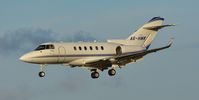 A6-HWK @ EGHH - Arriving runway 26 - by John Coates