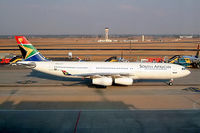 ZS-SLD @ FAJS - Airbus A340-212 [019] (South African Airways) Johannesburg Int~ZS 08/10/2003.Taken through the glass of the terminal.