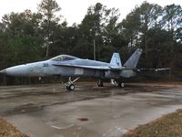 163483 - F/A-18C found discarded on a cement pad in the woods at Ft. Story. In great disrepair (leading edge flap on left wing missing, panels missing). - by Byron Hukee
