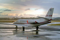 VH-HVM @ EGBJ - Cessna Citation Bravo [550-0984] Staverton~G 13/03/2004. Taken in a rainstorm as the sun is setting. - by Ray Barber
