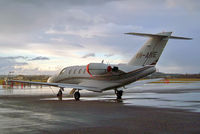 VH-ANE @ EGBJ - Cessna CitationJet CJ1 [525-0521] Staverton~G 13/03/2004. Taken in a rainstorm as the sun is setting. - by Ray Barber