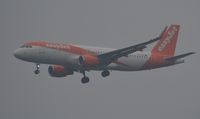 G-EZOY @ EGHH - Appearing out of the mist - by John Coates