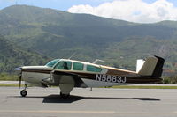 N5883J @ SZP - 1965 Beech S35 BONANZA, Continental IO-520-B 285 Hp, S35 first Bonanza with 285 Hp and fuselage stretch for optional fifth/sixth seat, taxi back after landing Rwy 22 - by Doug Robertson