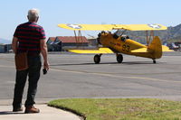 N75753 @ SZP - 1942 Boeing Stearman N75N1 (PT-17) as Navy N2S-4, Continental W670 220 Hp radial, taxi to Rwy 22 for flight exhibition after Aviation Museum of Santa Paula First Sunday Featured Aircraft discussion. Wistful man standing left? - by Doug Robertson
