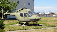 68-16830 @ OLM - The OH-58 is 68-16830, The OH-58A Kiowa, engine and rotor-less and without markings or identification with, in the background, a visitor from the State of Arkansaw OH-58A N911A. - by RAFOHunter