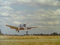 N4965V - I meet Bill Compton (B-25 Pilot) in the early 1970s at Abbotsford, Canada Airshow where he had his newly restored F6F-3 and we became friends fast...This picture he sent me, landing at his own private field.
He was a flower bulb farmer in Canby,Oregon. - by Bill Compton's Home Field