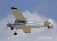 N3035B @ KOSH - Cessna 195B over Oshkosh - by Eric Olsen