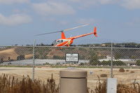 N344CF @ CMA - 2004 Robinson R44 RAVEN II, one Lycoming IO-540-AE1A5 6 cylinder flat-rated to 245 BHp, at SUN AIR JETS ramp, liftoff departure - by Doug Robertson