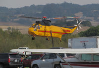 N1043T @ O69 - Croman Corp (White City, OR) 1982 Sikorsky S-61A rising out of the clutter at Petaluma Municipal Airport, CA temporary home base before leaving to make water drops on the devastating October 2017 Northern California wildfires