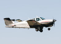 N950CA @ KRHV - Locally-based 1974 Beechcraft V35B Bonanza departing with another local Decathlon behind it. Lucky shot! - by Chris Leipelt