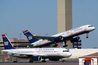 N908AW @ KPHX - Notice the helicopter at the nose of the airborne plane. - by Dave Turpie