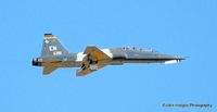 65-10391 @ KDYS - Gear going up - by John Hodges
