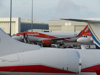 OE-IVQ @ EGGW - in a sea of easyjet at Luton - by Magnaman