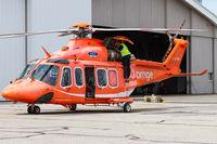 C-GYNK @ CYTZ - Mechanic working on the aircraft. - by Tim Lowe