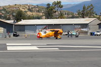 N100BU @ SZP - 1939 DORNIERE WERKE BU-133 JUNGMEISTER 'Angel', Lycoming O-360-A1D 180 Hp, original radial cowl retained, No.19 of 47 built, owner/pilot has FAA WRIGHT BROS. 50 YEAR Award, preflight for Rwy 22. Please see SZP Airport photos P. 41 & 42 for Award Ceremony, - by Doug Robertson