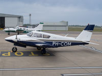 PH-COM @ EGJB - West parking, Guernsey - by alanh