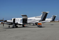 N828SA @ KSQL - Pair of Surf Airlines Pilatus PC-12/47E await passengers at the company's SF Bay Area terminal - by Steve Nation